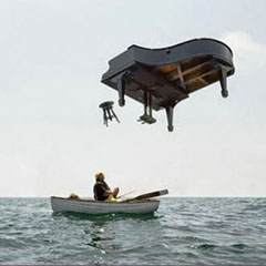 man in a boat under a falling piano